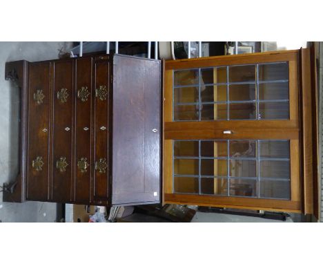 A George III oak Bureau with hinged fall and four long graduated drawers under, on pierced bracket feet, surmounted by an ass