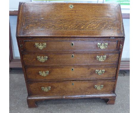 A George III oak Bureau with hinged fall and three long drawers under, on bracket feet.  3' 2" (97cms) wide. 