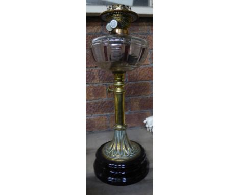 Another Table Oil Lamp with glass reservoir and adjustable glass column on a circular foot.  