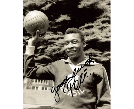 PELÉ: (1940-2022) Brazilian footballer. Signed 8 x 10 photograph of the young Pele standing outdoors in a half-length pose we