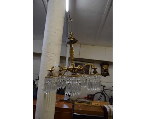 A five branch gilt metal chandelier with glass drops