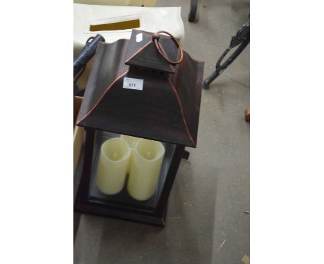 A garden lantern and battery candles