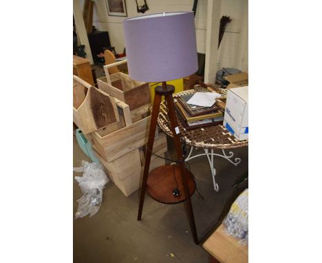 A tripod, standard lamp and shade