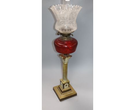 A Corinthian column brass oil lamp with shades