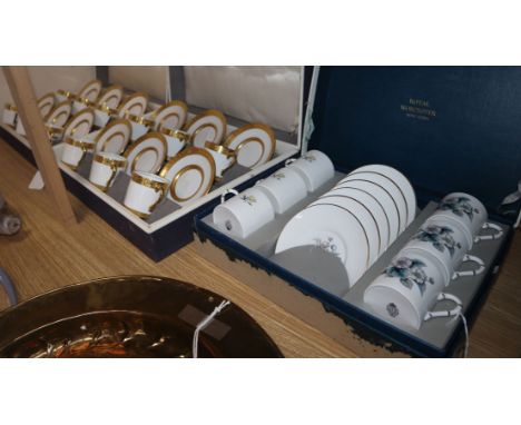 Two matching Royal Worcester gilt-bordered coffee sets and another Royal Worcester coffee set (3, boxed)