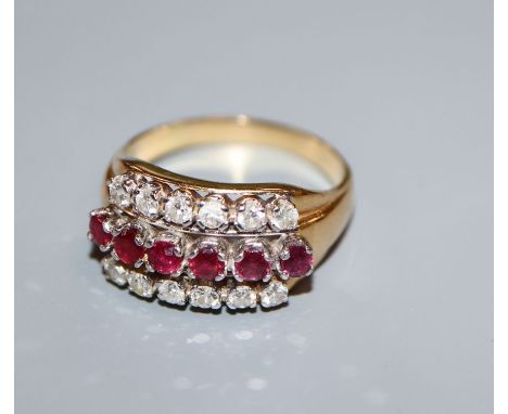 An 18k gold ruby and diamond triple row ring, size S