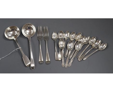 A George III beaded Old English pattern silver sauce ladle, a Victorian fiddle pattern sauce ladle, two dessert forks, a set 