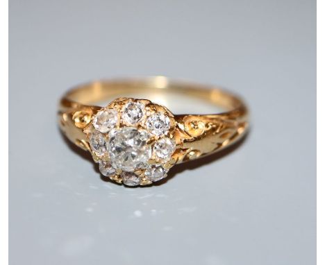 A gold and diamond cluster ring, size O