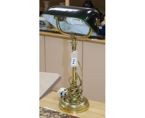 A brass desk lamp with green glass shade