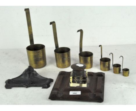 Two early 20th century inkwells and a set of brass measuring jugs, comprising an Art Nouveau desk stand and inkwell and a woo