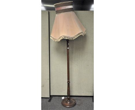 A turned mahogany standard lamp with original fabric shade, 155cm high excluding shade
