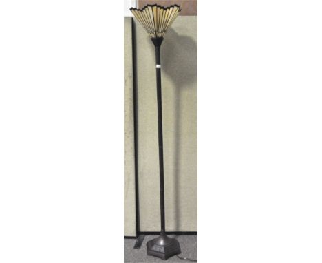 A metal lamp stand on a octagonal boase, with a stained glass Tiffany style shade in yellow and red, height 183cm