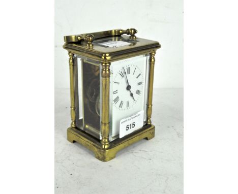 A 20th century carriage clock, 8 day movement, white enamel dial with Roman numerals contained in brass case with bevelled gl