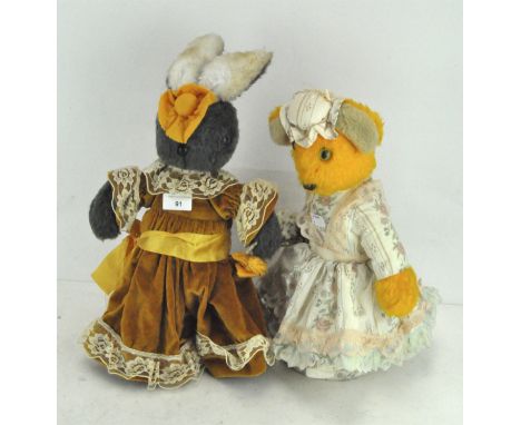 Two stuffed animal door stops modelled as a rabbit and a bear, each dressed in traditional attire