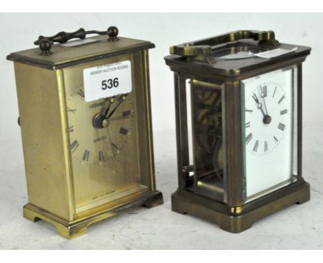 A 20th century carriage clock, white dial with Roman numerals, in a brass case with glass panels, height (including handle) 1