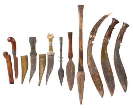 A small collection of edged weapons, comprising: two kukris with wooden hilts, another with staghorn hilt, three various Afri
