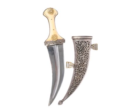 λ A fine South Arabian dagger (jambiya), broad curved blade 6.5 in., with narrow medial ridge; hilt of ivory with fret-carved