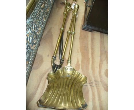 A collection of Georgian brass fire irons 
To include a pair of coal tongs, with turned handle and scroll design hinges termi