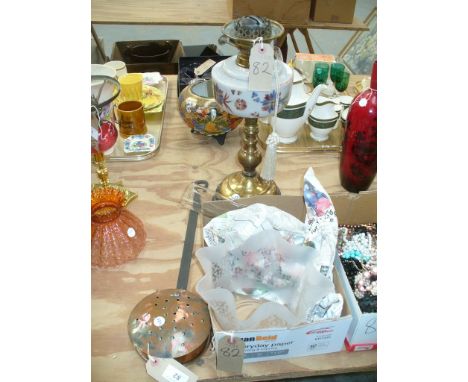 A 19th Century copper chestnut roaster and a Victorian oil lamp with an opaque glass reservoir upon a knopped brass column an