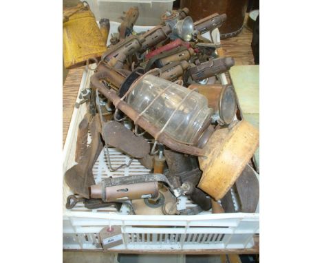 A Collection of brass blow lamps, a " Well's unbreakable " oil lamp, storm lamp, cobblers lasts, etc.