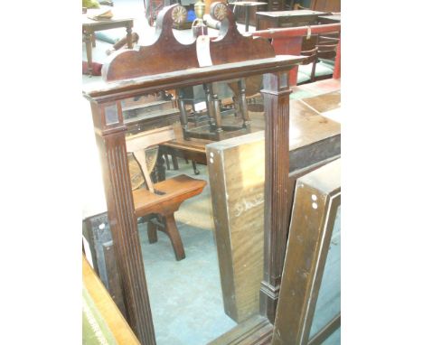 An early 20th Century mahogany over mantle mirror
The scroll architectural cresting adorned with gilt brass roundel and campa