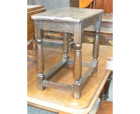 An Antique oak joint stool.