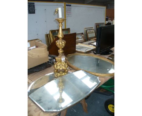 An ornate gilt wood column table lamp raised on a tri form base and three paw feet, a gilt framed oval wall mirror and 2 othe