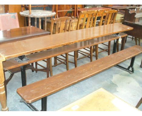 A late 19th/ early 20th Century stained hardwood and iron bench and table combined, the rectangular plank top with canted cor