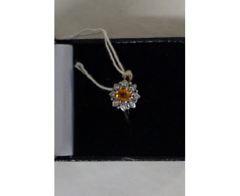 A fire opal and diamond set cluster ring, the circular cut fire opal to a diamond set surround, to an 18ct yellow gold shank,