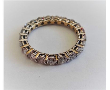 A white gold and diamond set full eternity ring, mounted with circular cut diamonds, detailed 750,  ring size L and a half.