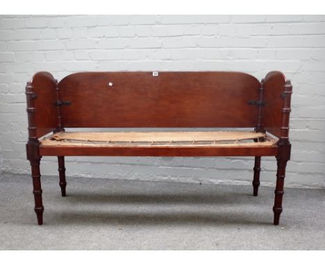 An early 19th century mahogany campaign sofa on ring turned supports, 136cm wide x 82cm high x 53cm deep.  Provenance, Remove