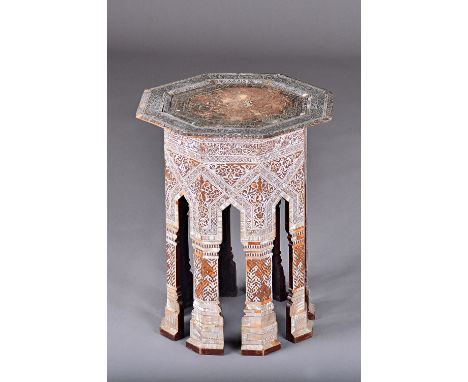 An early 20th century Moorish octagonal occasional table profusely inlaid with mother-of-pearl, 47cm wide x 59cm high. Illust