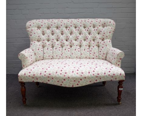 A Victorian style button back two seater sofa, on baluster turned supports, 124cm wide x 97cm high.