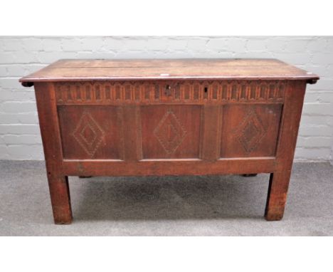 A 17th century oak coffer, the twin plank top over triple panel front on high stile feet, 122cm wide x 73cm high x 48cm deep.
