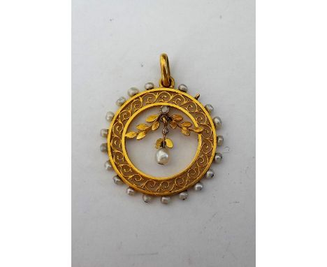 A gold, seed pearl and diamond set pendant, circa 1910, of circular form, the centre with a spray motif, supporting a seed pe