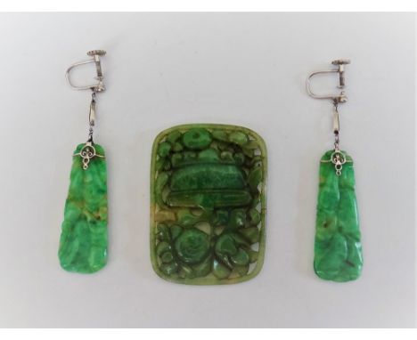 A pair of carved jade pendant earrings, decorated with fruit, the tops having screw fittings and a carved jade curved rectang