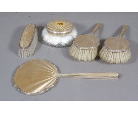 A silver and enamel five piece dressing table set, comprising a clothes brush, two hair brushes, a hand mirror and comb, (a.f