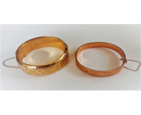 A 9ct gold loaded oval hinged bangle, the front with floral engraved decoration, Birmingham 1963 (the clasp broken) and anoth