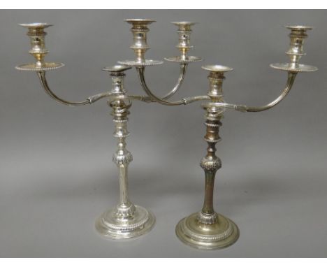 A pair of silver three light table candelabra, each with a fluted column below a foliate decorated knopp to the stem, with sc