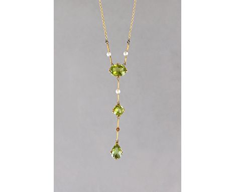 A gold, peridot and seed pearl pendant necklace, mounted with a pear shaped peridot to the drop, a circular cut peridot to th