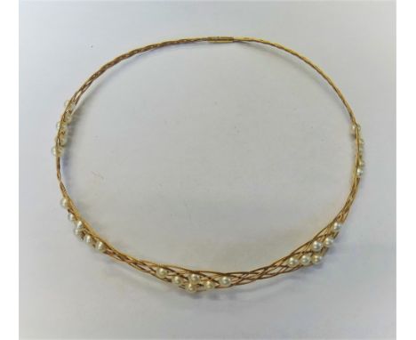 A gold and cultured pearl collar necklace, in an interwoven wirework design, spaced with groups of cultured pearls at interva