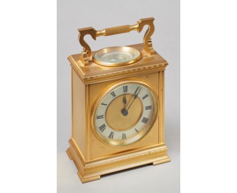 A French gilt brass mantel timepiece with thermometer and compassCirca 1900With shaped fluted handle above a moulded cornice,