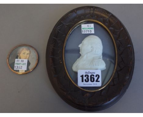 A Tassie style miniature of Louis XVIII housed in a carved wooden oval frame, 15cm high overall and one further small portrai