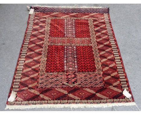 A Tekke Turkeman engsi, the madder quarter sectioned field bearing candelabra, a leaf border, skirt end, 153 x 123cm. 