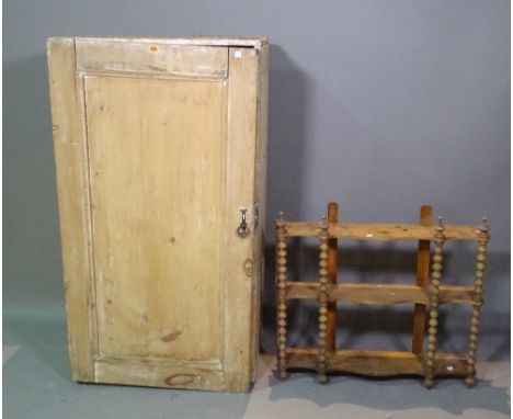 An early 20th century pine cupboard with panelled door, 64cm wide x 118cm high, and an early 20th century stained pine three 