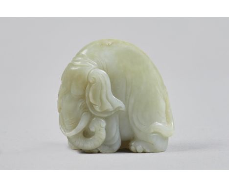 A small Chinese pale celadon jade figure of an elephant, Qing Dynasty, carved standing four-square, 4.5cm. high. Illustrated.