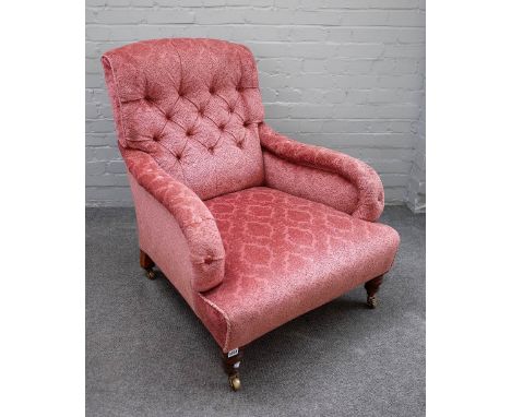A mid Victorian easy armchair with button back and over stuffed arms on turned supports, the back leg is stamped 2702, 75cm w