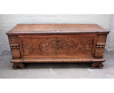 An 18th century and later Italian walnut Cassone, the single plank top over carved panel front on shaped bracket feet, 167cm 