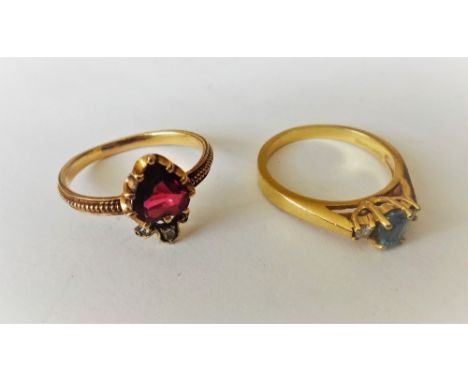 A gold, garnet and rose diamond set ring, designed as a rose diamond coronet above a heart shaped garnet, ring size N and an 