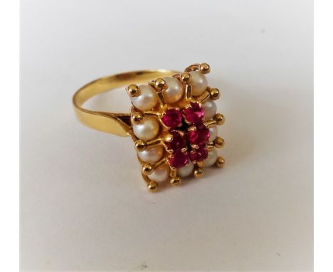 A gold, synthetic ruby and cultured pearl rectangular cluster ring, claw set with six circular cut synthetic rubies to the ce